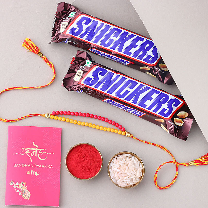 Sneh Red and Yellow Bead Rakhi with Snickers Chocolates: Rakhi With Chocolates