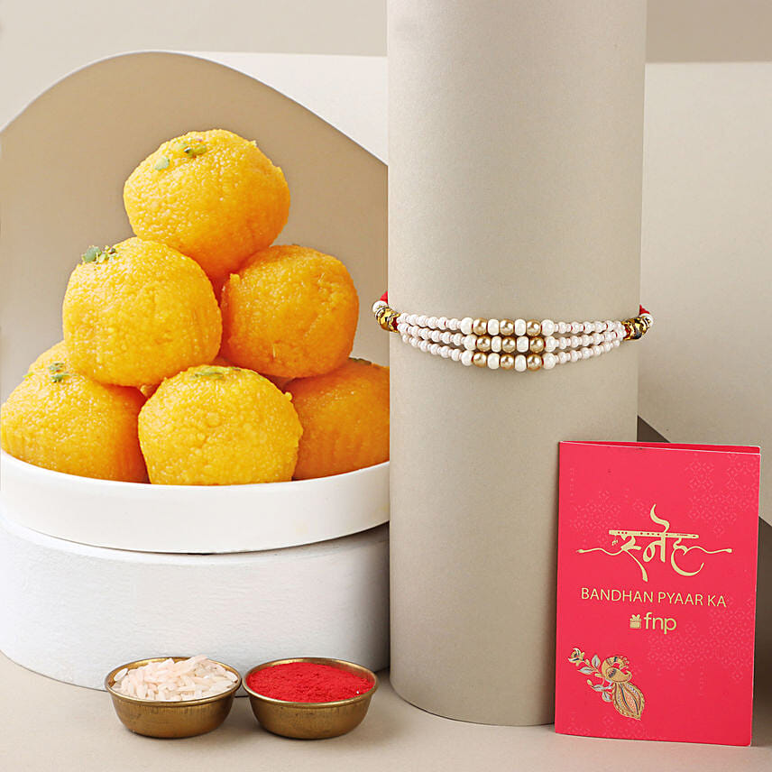 Sneh White Pearl Rakhi with Motichoor Laddoo: Rakhi Gifts