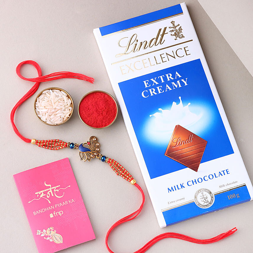 Sneh Blue Peacock Designer Rakhi with Lindt Extra Creamy Milk Chocolate: 