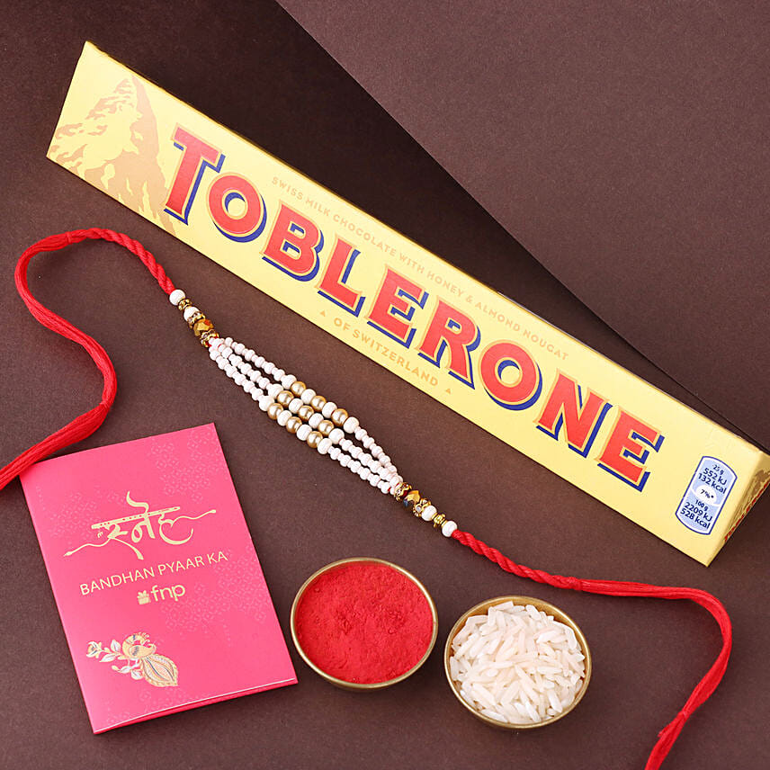 Sneh White Pearl Bead Rakhi with Toblerone Chocolate: Rakhi 