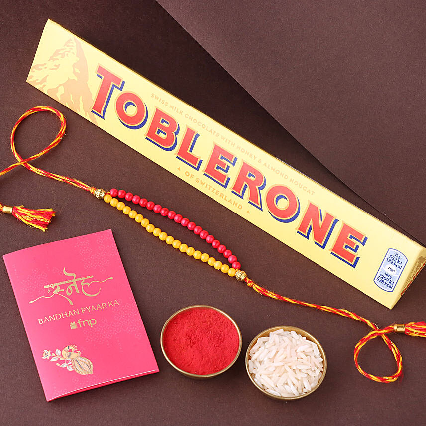 Sneh Red and Yellow Bead Rakhi with Toblerone Chocolate: 