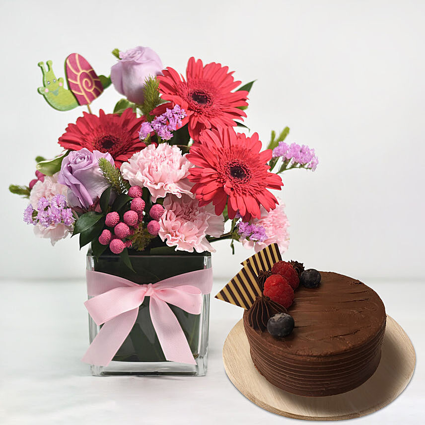 Lovely Mixed Flowers In Glass Vase With Cake