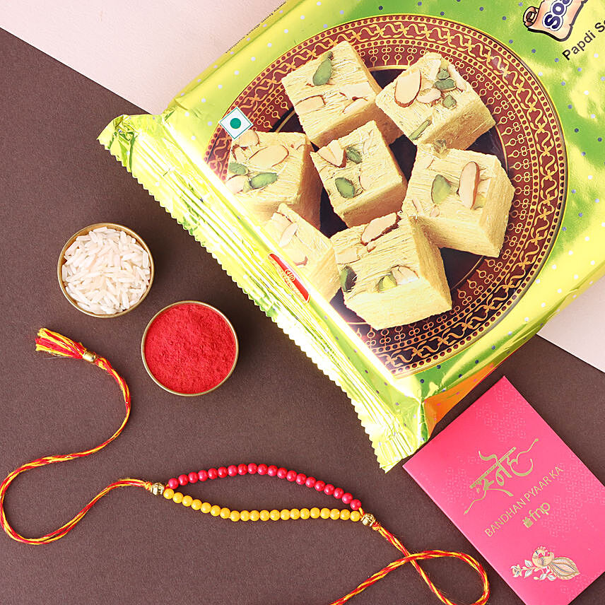 Sneh Red and Yellow Bead Rakhi with Soan Papdi
