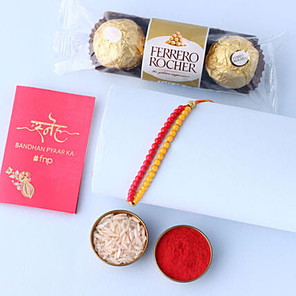 Sneh Red and Yellow Bead Rakhi with Ferrero Rocher: Rakhi With Sweets