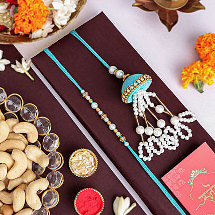 Tranquil Teal Jhumar Bhaiya Bhabhi Pearl Rakhi Set N Cashew Combo: Rakhi With Dryfruits