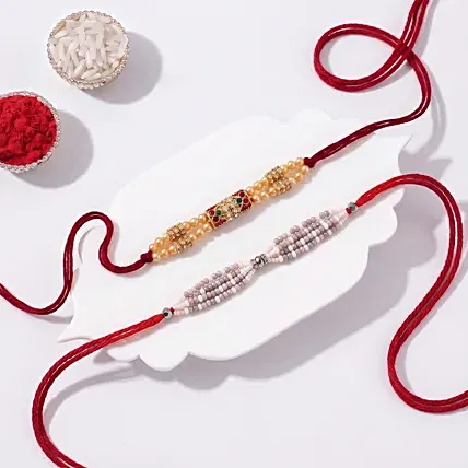 Red & Green Designer and Pearl Rakhi Set: Set Of-2 Rakhi