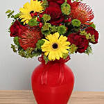 Mixed Flowers Arrangement In Red Glass Vase