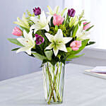 Medley Of Lilies And Tulips In Glass Vase