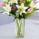 Medley Of Lilies And Tulips In Glass Vase