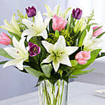 Medley Of Lilies And Tulips In Glass Vase