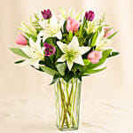 Medley Of Lilies And Tulips In Glass Vase