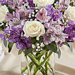 White And Purple Floral Bunch In Glass Vase