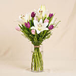 Medley Of Lilies And Tulips In Glass Vase