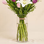 Medley Of Lilies And Tulips In Glass Vase