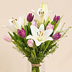 Medley Of Lilies And Tulips In Glass Vase