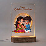 Divine Ganesha Idol and Krishna Rakhi with LED Lamp Gift Set